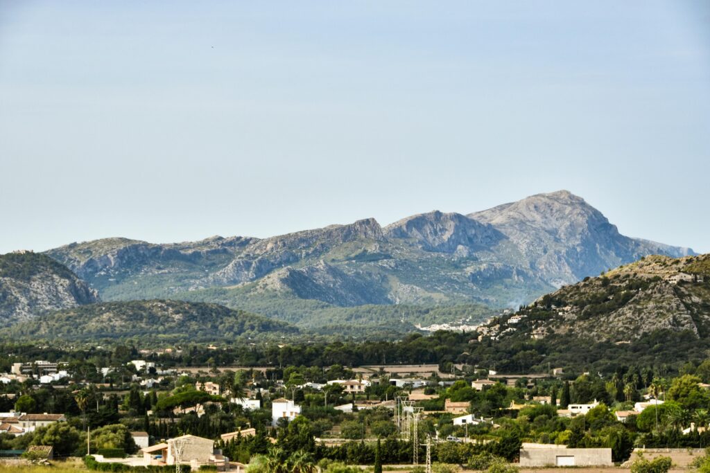 Picturesque mountainous landscape with green countryside and blue sky, perfect for nature lovers.